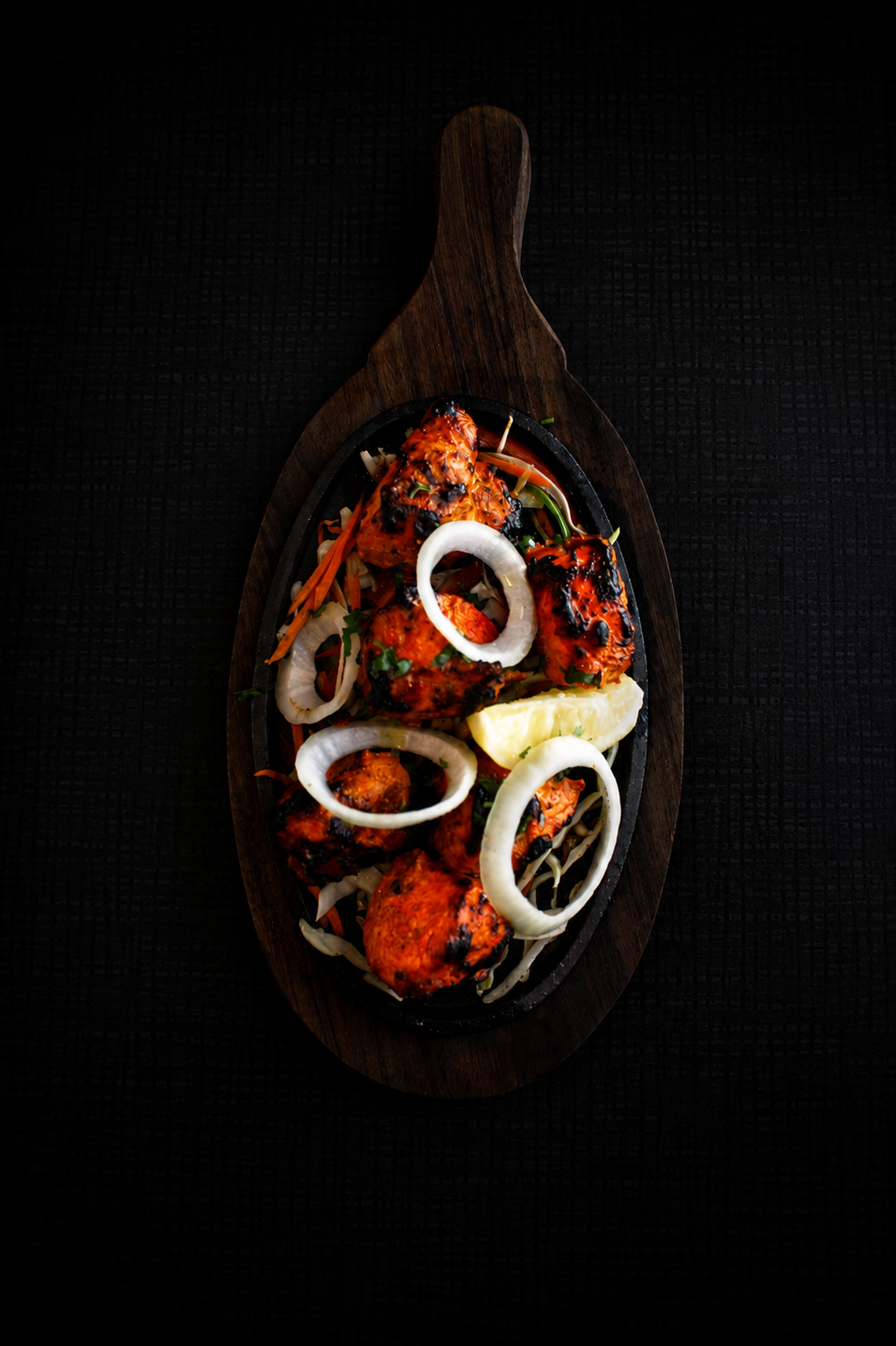 Tandoori chicken on a wooden board